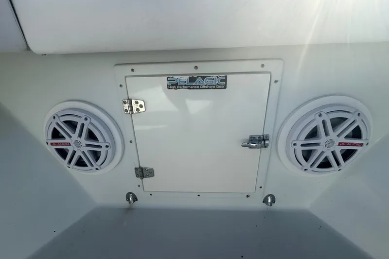 Slide: The Image of 2003 Contender 27 Open boat engine and transom detail by the water. - 23