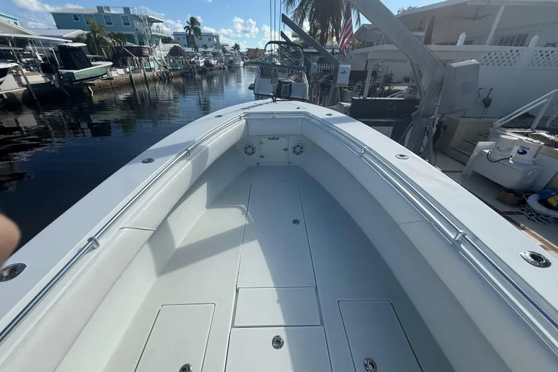 Slide: The Image of 2003 Contender 27 Open boat with coiled hose storage in the deck. - 25