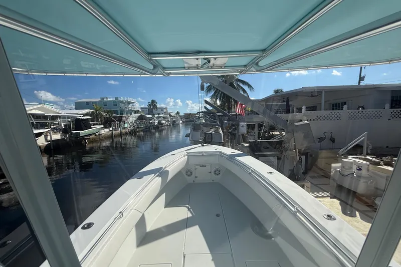 Slide: The Image of 2003 Contender 27 Open boat console with Garmin navigation system and steering wheel. - 26