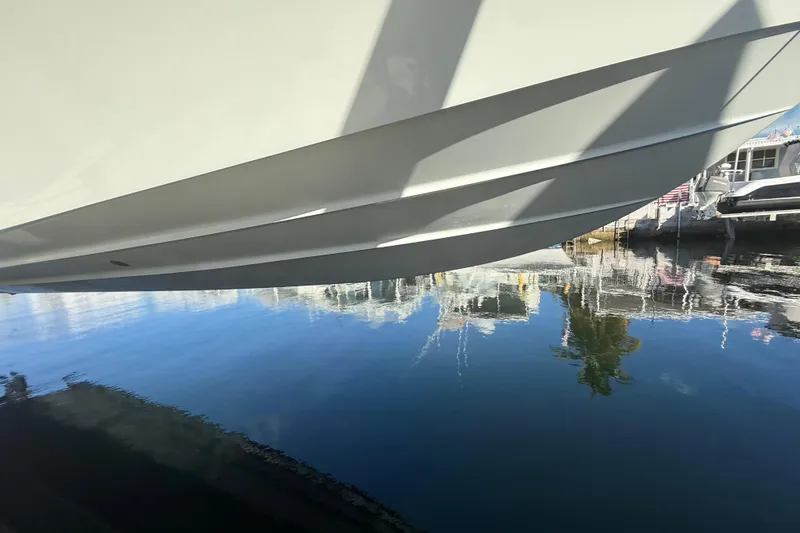 Slide: The Image of 2003 Contender 27 Open boat cruising on calm blue waters. - 4
