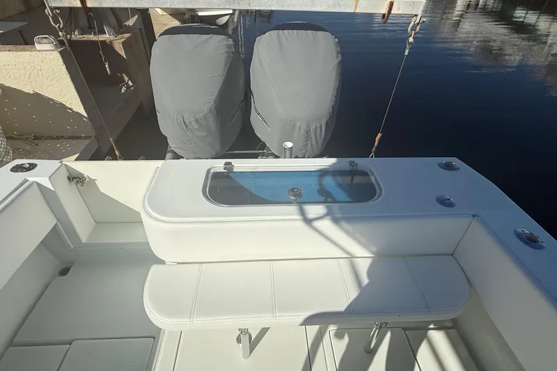 Slide: The Image of 2003 Contender 27 Open boat cruising on calm blue waters. - 5