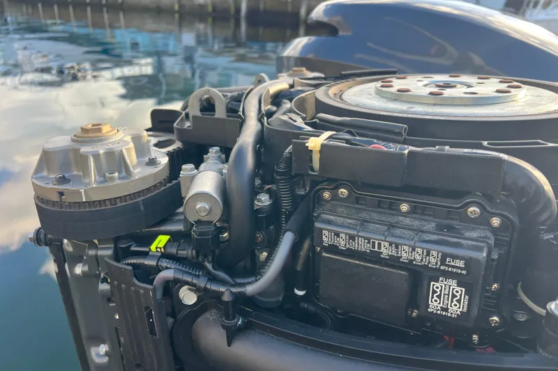 Slide: The Image of Close-up of a 2003 Contender 27 Open boat engine, showing detailed components. - 53