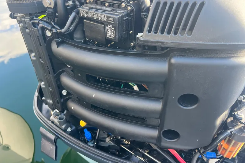 Slide: The Image of Close-up of a 2003 Contender 27 Open boat engine, showcasing mechanical details. - 57