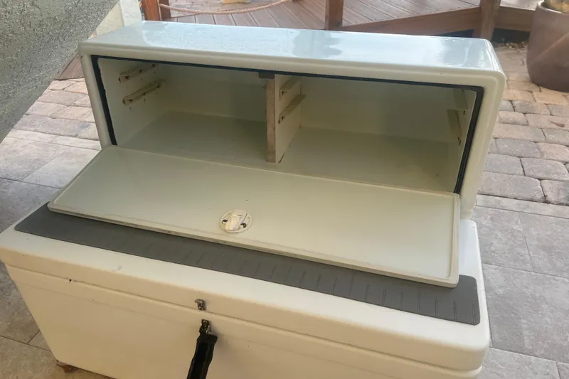 Slide: The Image of Open storage compartment on a 2003 Contender 27 Open boat, showing interior shelves. - 61