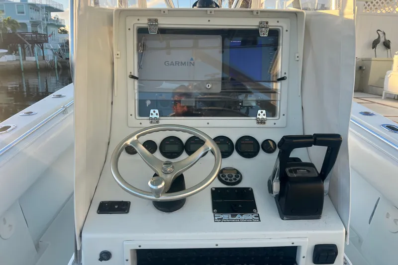 Slide: The Image of 2003 Contender 27 Open boat console with Garmin navigation system and steering wheel. - 64