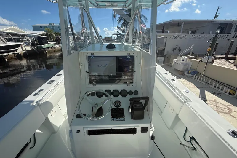 Slide: The Image of 2003 Contender 27 Open boat on calm water under a partly cloudy sky. - 7