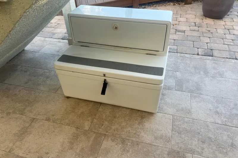 Slide: The Image of White storage box on tiled floor, possibly from a 2003 Contender 27 Open boat. - 71