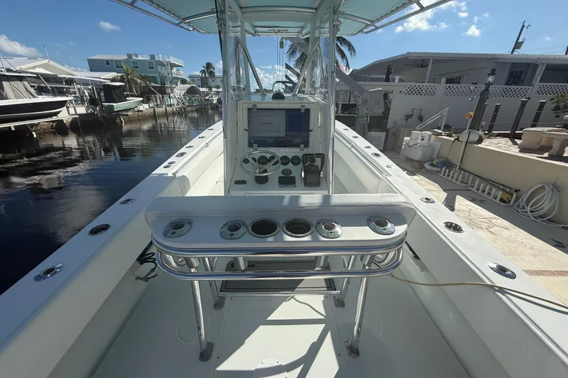 Slide: The Image of 2003 Contender 27 Open boat on calm blue waters under clear sky. - 8