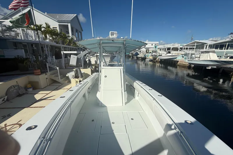 Slide: The Image of 2003 Contender 27 Open boat on calm blue water under clear sky. - 9