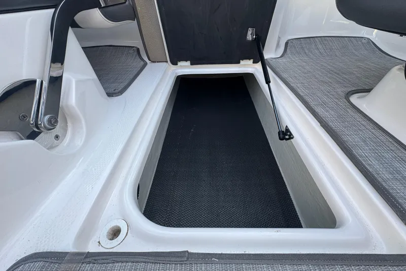 Slide: The Image of 2018 Chaparral Vortex 203 VRX boat interior storage compartment with textured flooring. - 17