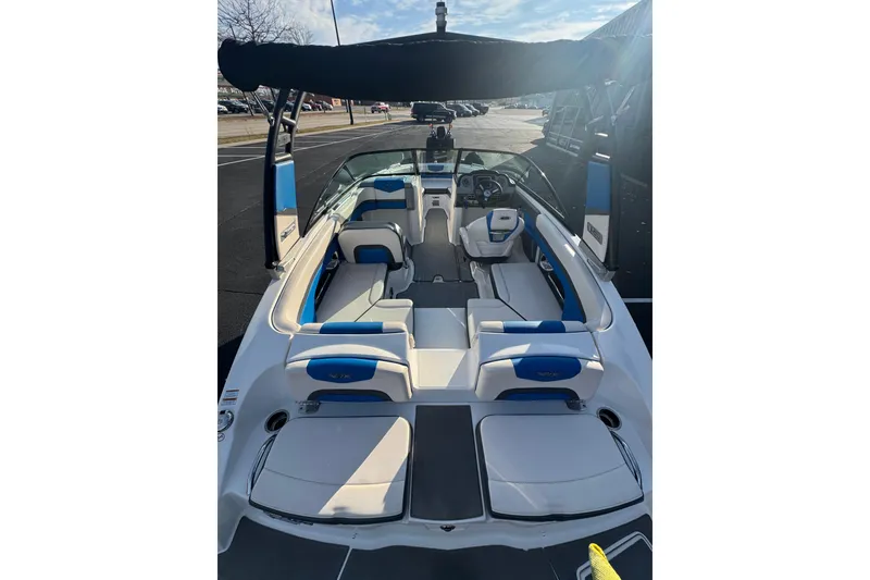 Slide: The Image of 2018 Chaparral Vortex 203 VRX boat with blue and white interior, docked under sunny skies. - 25