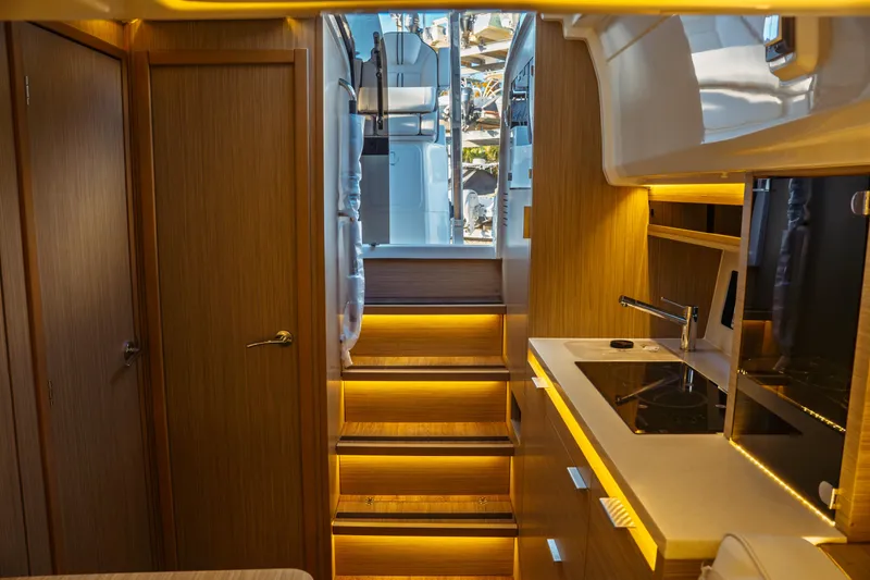 Slide: The Image of 2025 Jeanneau Leader 10.5 WA Series 2 interior with modern wood finish and seating area. - 27