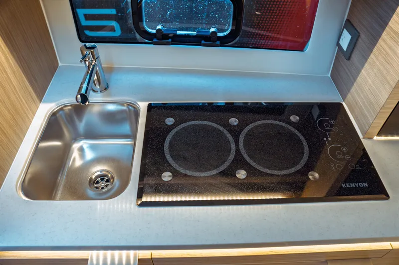 Slide: The Image of Modern kitchenette in 2025 Jeanneau Leader 10.5 WA Series 2 boat, featuring sleek design and lighting. - 30