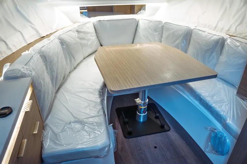 Slide: The Image of Interior of 2025 Jeanneau Leader 10.5 WA Series 2 with cozy seating and wooden table. - 32