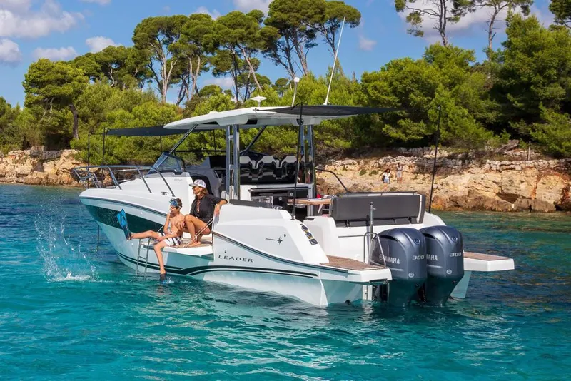 Slide: The Image of 2025 Jeanneau Leader 10.5 WA Series 2 boat with dual engines, docked outdoors. - 4