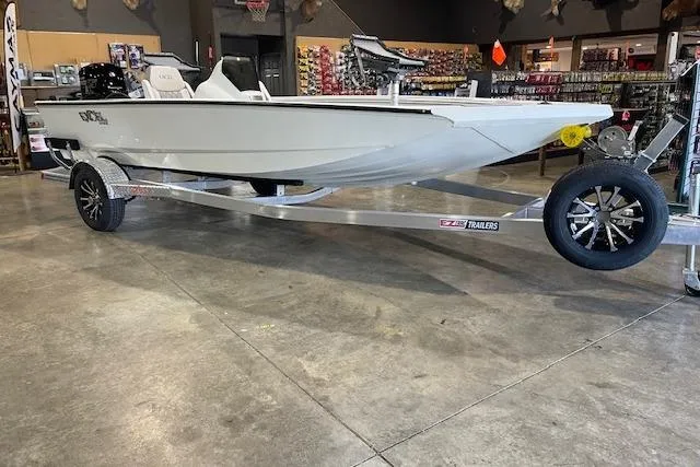 The Image of 2026 Excel 183C boat on trailer in showroom, featuring sleek design and modern features. - 0