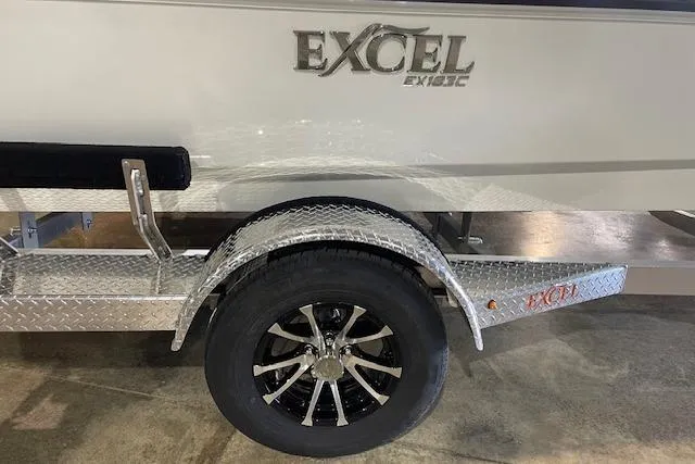 Slide: The Image of 2026 Excel 183C boat trailer with diamond plate fender and black alloy wheel. - 2