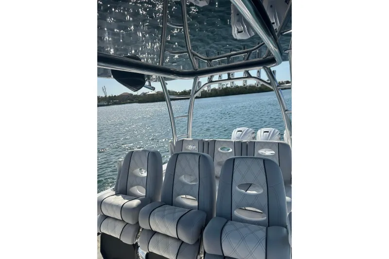 Slide: The Image of 2025 Contender 39 ST boat interior with luxurious seating on a sunny day. - 8