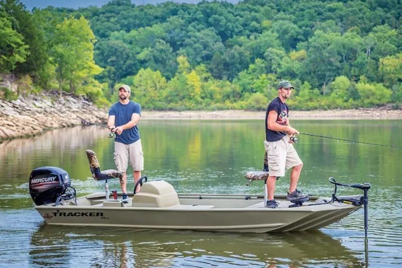 Slide: The Image of Two people fishing on a 2026 Tracker Grizzly 1648 S boat in a scenic lake. - 11