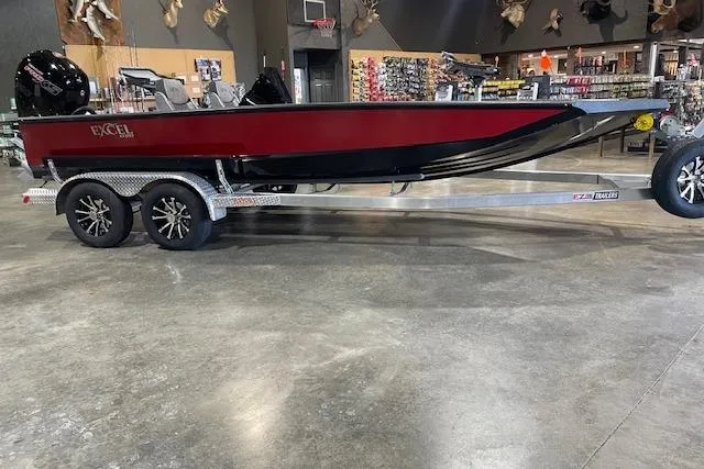 The Image of 2026 Excel EX203 boat on trailer in showroom, red and black design. - 0