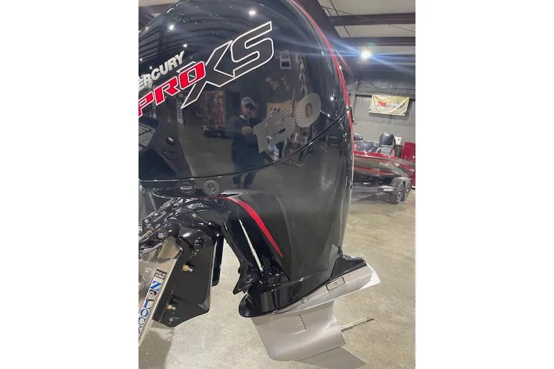 Slide: The Image of 2026 Excel EX203 boat with Mercury Pro XS outboard motor in showroom. - 4