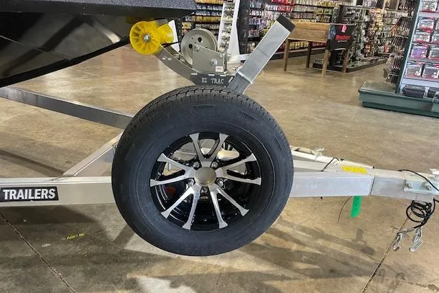 Slide: The Image of Trailer wheel and frame in a store, featuring Excel EX203 model, 2026. - 7