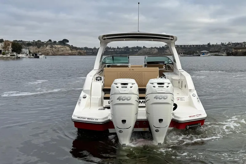 Slide: The Image of 2023 Sea Ray SLX 350 boat with dual engines on a calm waterway. - 10