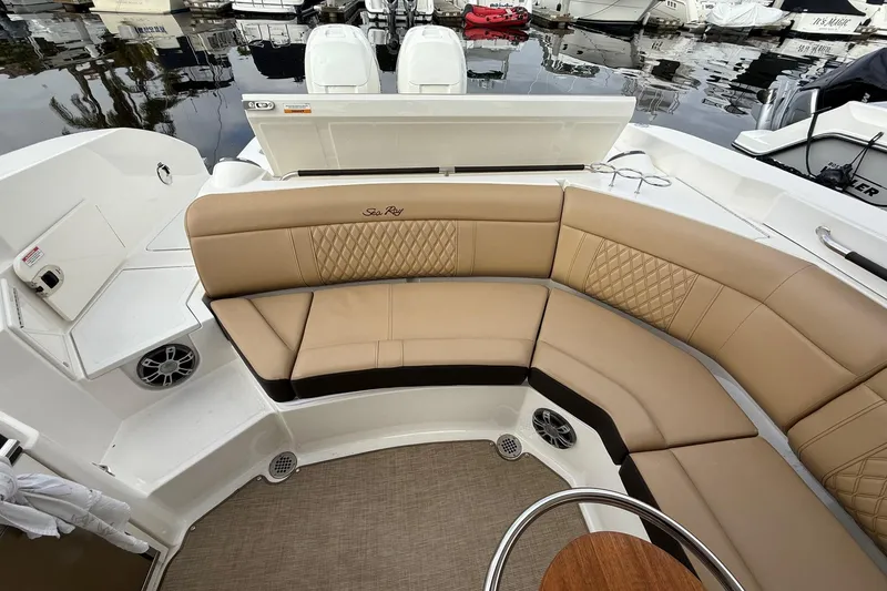 Slide: The Image of 2023 Sea Ray SLX 350 boat with open canopy, docked at marina under cloudy sky. - 11