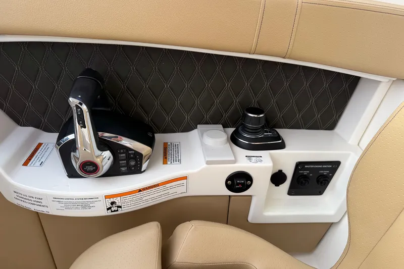 Slide: The Image of 2023 Sea Ray SLX 350 dashboard with steering wheel and navigation display. - 28