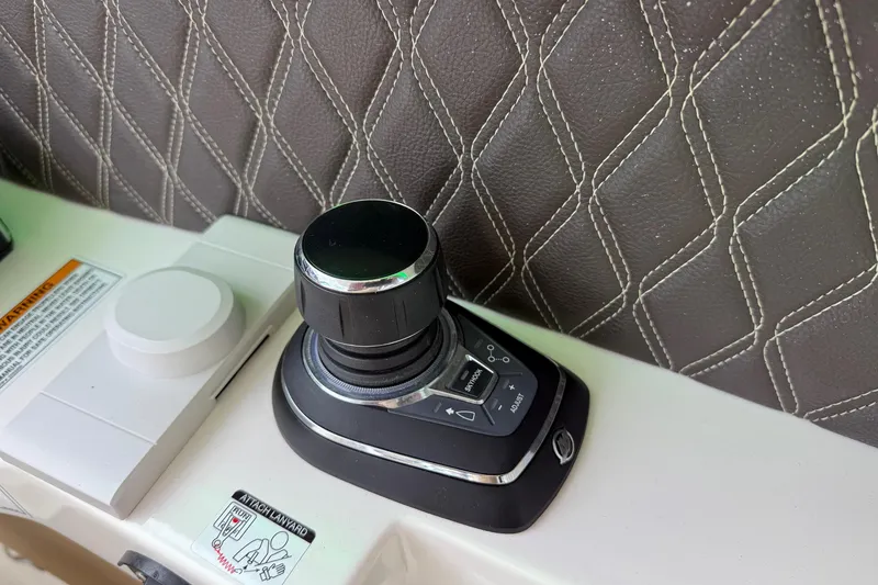 Slide: The Image of 2023 Sea Ray SLX 350 boat control panel with joystick and throttle. - 29