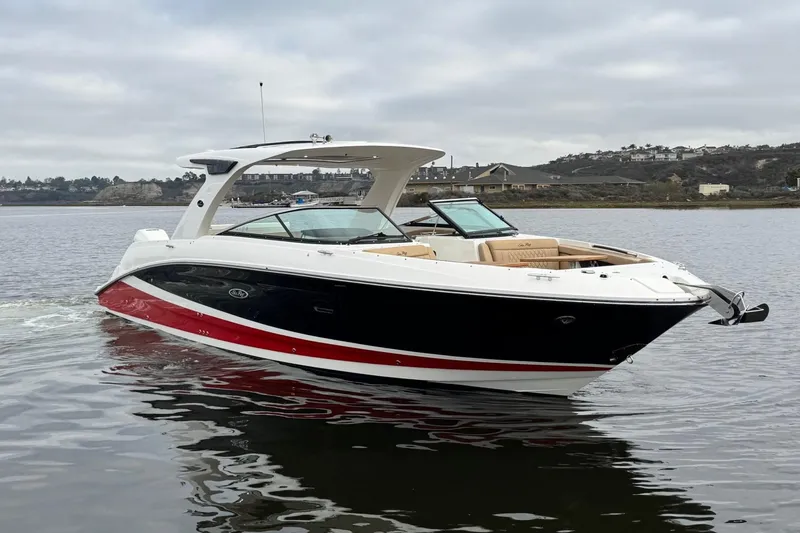 Slide: The Image of 2023 Sea Ray SLX 350 boat on calm water, featuring sleek design and modern outboard engines. - 3