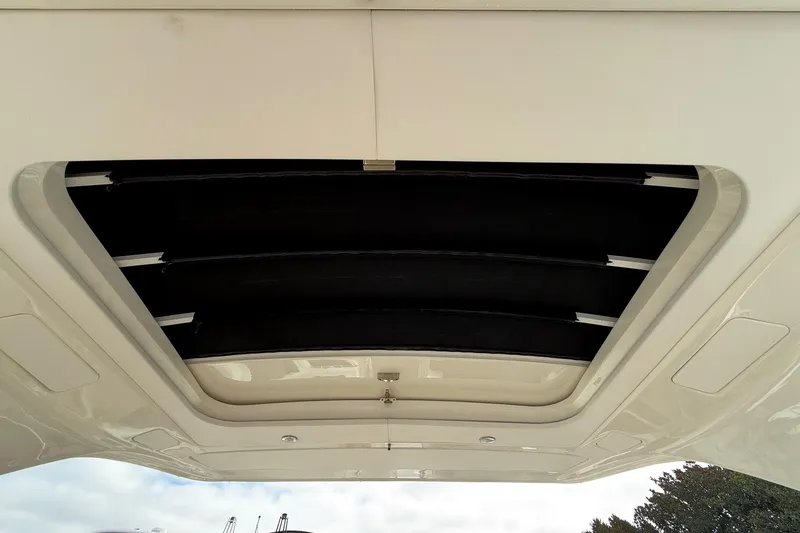 Slide: The Image of Joystick control on 2023 Sea Ray SLX 350 boat, with quilted leather background. - 30