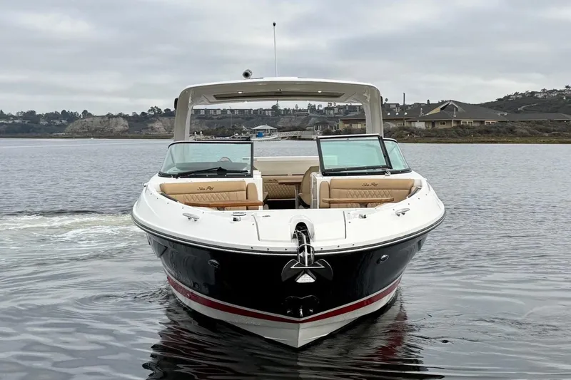 Slide: The Image of 2023 Sea Ray SLX 350 boat on calm water, featuring sleek black and red design. - 4