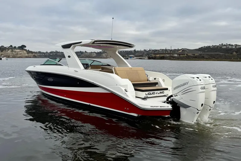 Slide: The Image of 2023 Sea Ray SLX 350 boat with twin Mercury engines on a calm lake. - 9