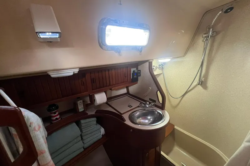 Slide: The Image of Bathroom interior of a 1994 Island Packet 44 cutter sailboat, featuring sink and shower. - 109