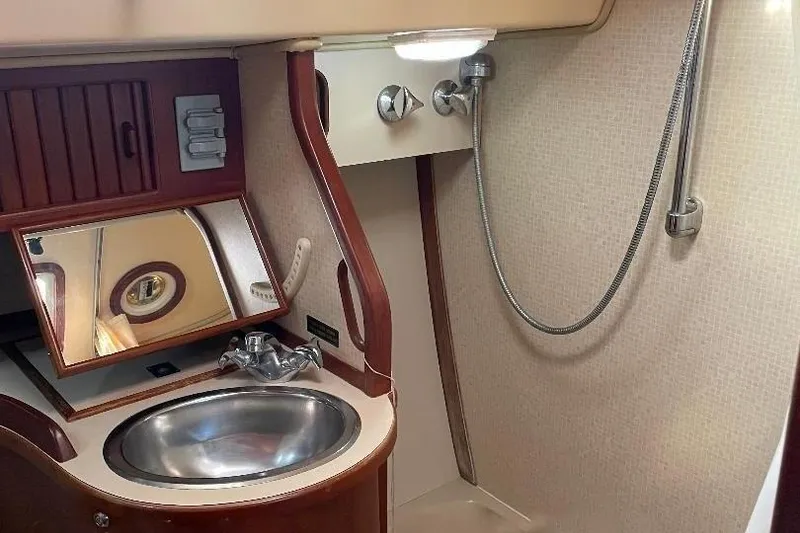 Slide: The Image of Island Packet 44 cutter 1994 bathroom with sink, mirror, and showerhead. - 110