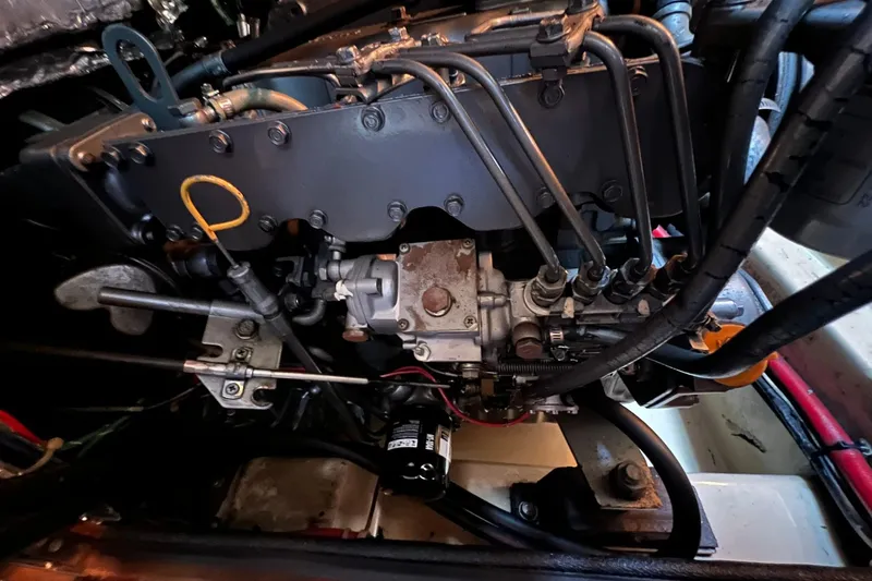 Slide: The Image of Engine compartment of a 1994 Island Packet 44 cutter sailboat, showcasing mechanical components. - 113