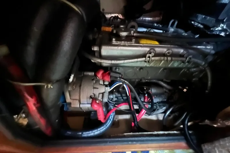 Slide: The Image of Engine compartment of a 1994 Island Packet 44 cutter sailboat, showing wiring and components. - 116