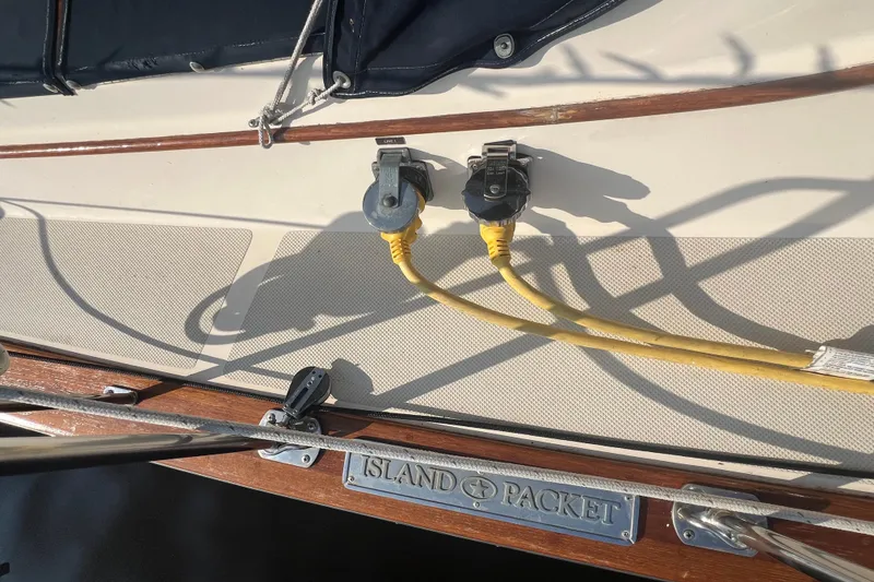 Slide: The Image of 1994 Island Packet 44 cutter sailboat deck with yellow power cables connected. - 29