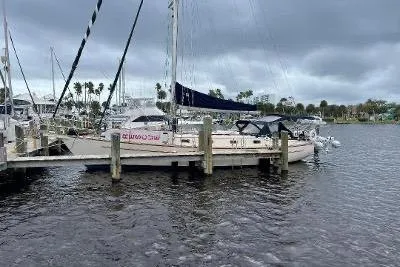 Slide: The Image of 1994 Island Packet 44 cutter sailboat docked on a cloudy day. - 3