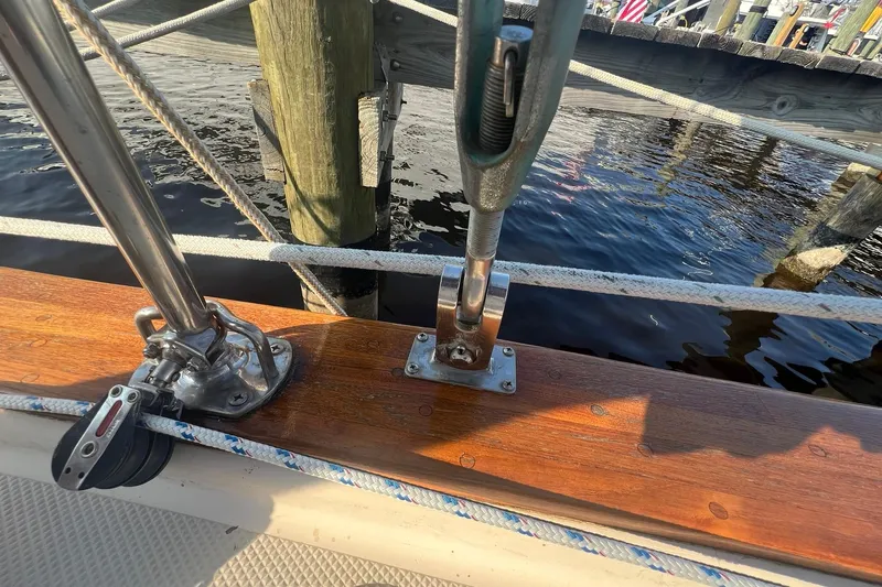 Slide: The Image of Close-up of 1994 Island Packet 44 cutter deck with polished wood and metal fittings. - 35