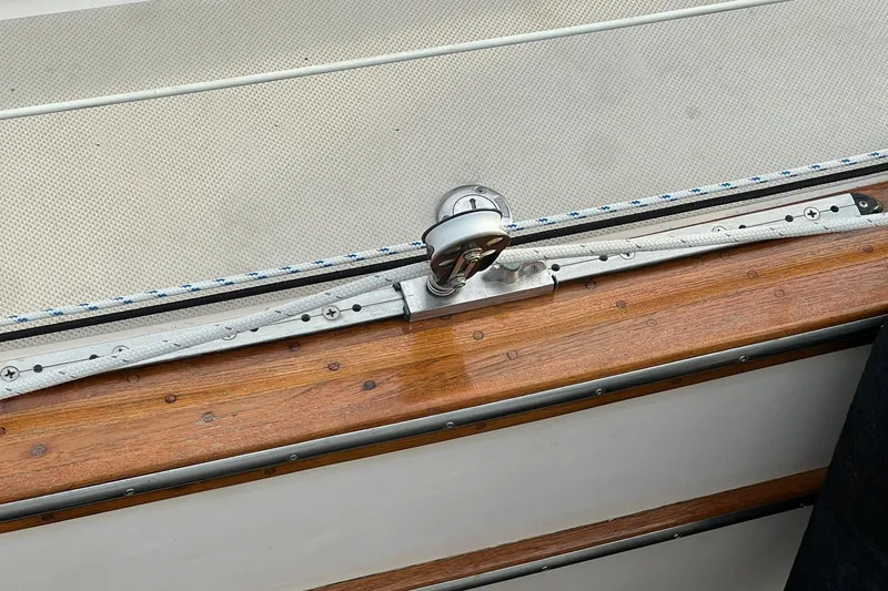 Slide: The Image of Close-up of a 1994 Island Packet 44 cutter sailboat's deck hardware and wood trim. - 39