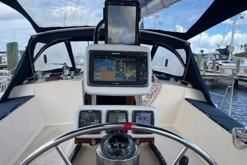 Slide: The Image of Cockpit of 1994 Island Packet 44 cutter with navigation equipment and steering wheel. - 48