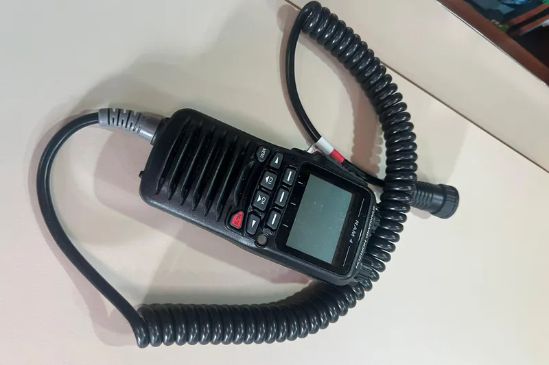 Slide: The Image of Handheld marine radio with coiled cord on Island Packet 44 cutter, 1994 model. - 50