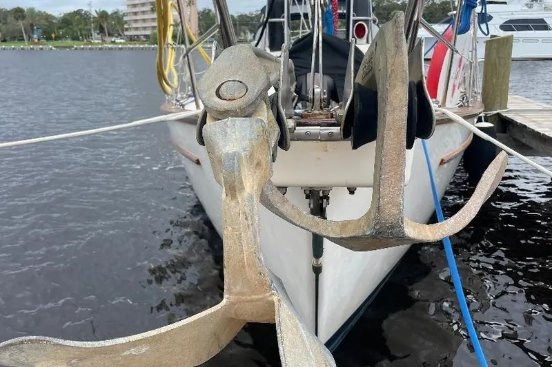 Slide: The Image of 1994 Island Packet 44 cutter with dual anchors docked at marina. - 53