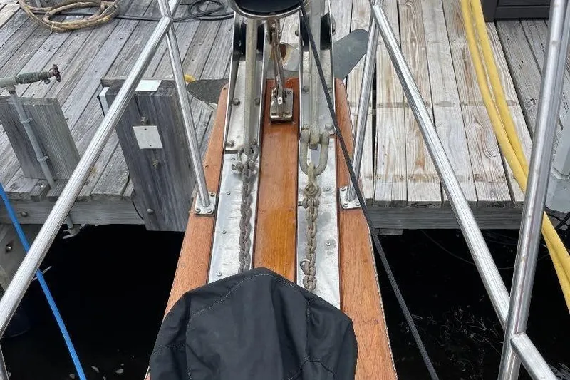 Slide: The Image of Bow of 1994 Island Packet 44 cutter with anchor chain and dock view. - 54