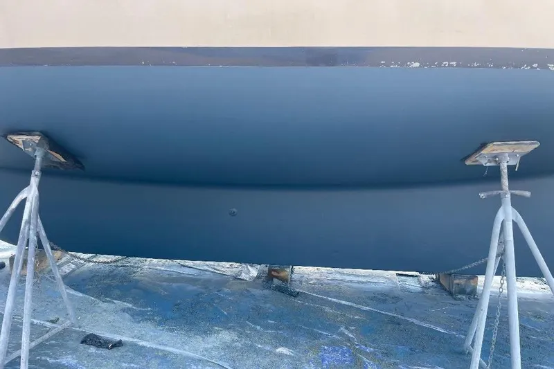 Slide: The Image of 1994 Island Packet 44 cutter sailboat hull on stands, undergoing maintenance. - 59