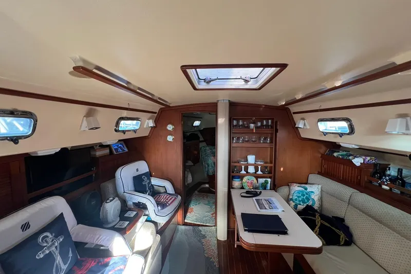 Slide: The Image of Interior of 1994 Island Packet 44 cutter, featuring cozy seating and nautical decor. - 61