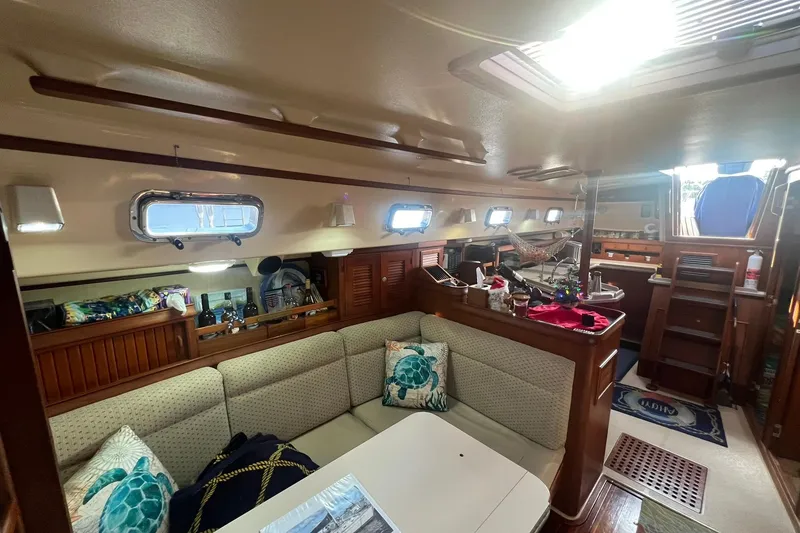 Slide: The Image of Interior of 1994 Island Packet 44 cutter sailboat, featuring cozy seating and nautical decor. - 63