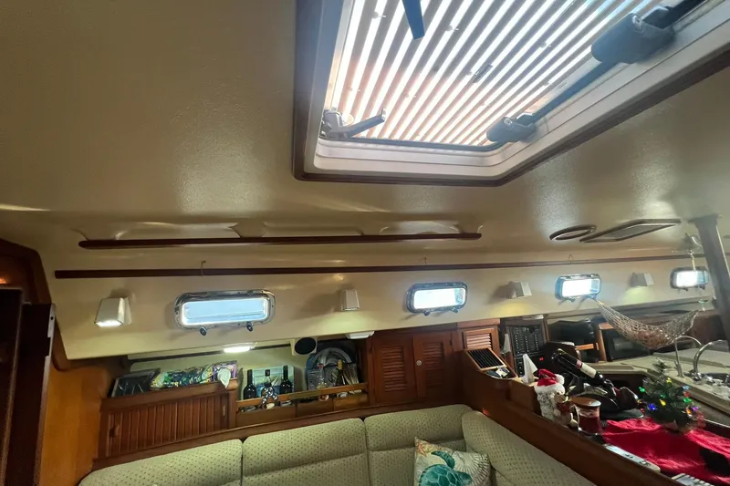 Slide: The Image of Interior of 1994 Island Packet 44 cutter sailboat with skylight and cozy seating area. - 65